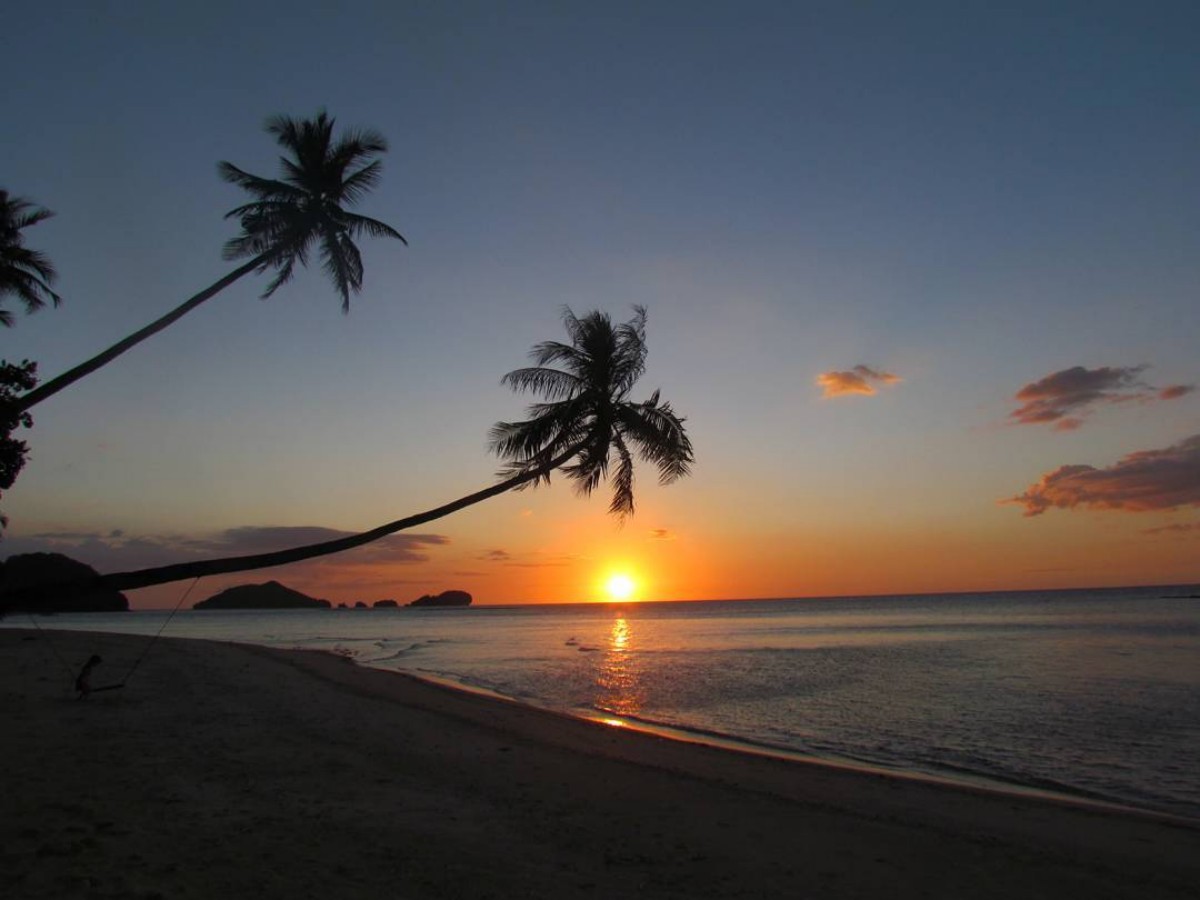 The tropical sea breeze blows gently, and the sun is just not dazzling